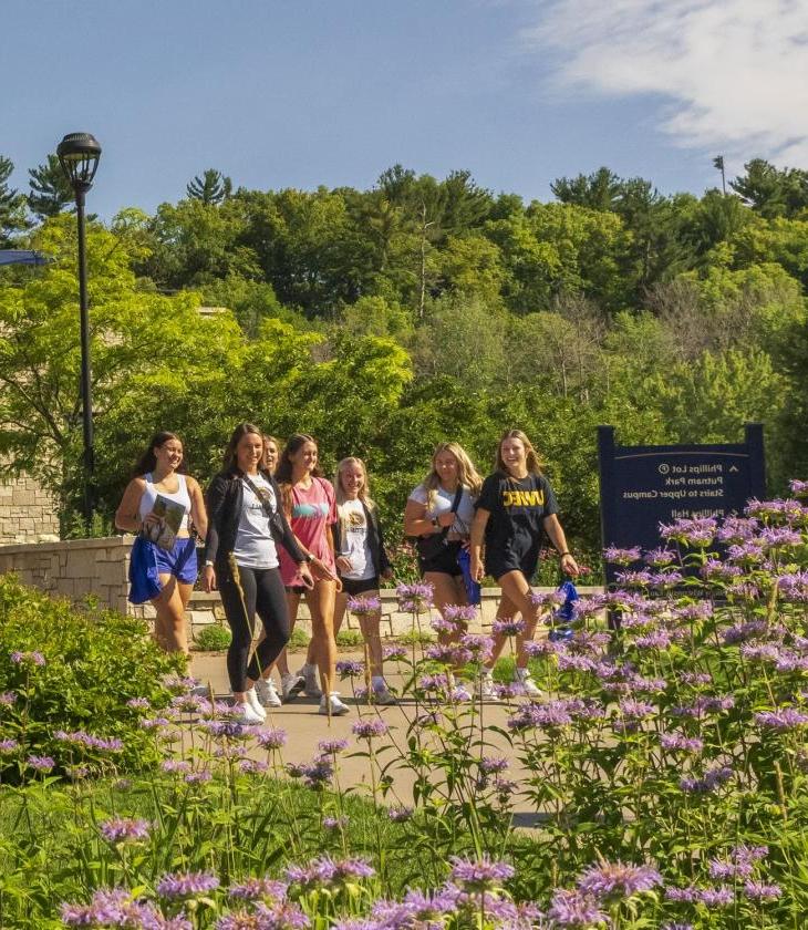 Students walk across the bridge in front of Davies Student Center